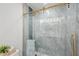 Elegant tiled shower with gold trim and a clear glass sliding door at 205 W Wheeler Rd, Seffner, FL 33584
