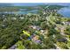 Aerial view of property showcasing pool and lush surroundings in neighborhood setting at 211 Arlington E Ave, Oldsmar, FL 34677