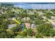Aerial view of a property with a pool and landscaping in a scenic neighborhood at 211 Arlington E Ave, Oldsmar, FL 34677