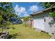 Backyard with well-kept lawn, shed, and above-ground swimming pool at 211 Arlington E Ave, Oldsmar, FL 34677