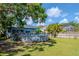 Backyard view highlighting an above-ground pool and spacious green lawn at 211 Arlington E Ave, Oldsmar, FL 34677