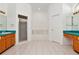 This bathroom features dual sinks with teal countertops, a soaking tub, and a separate walk-in shower at 211 Arlington E Ave, Oldsmar, FL 34677