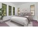 This bedroom features neutral walls with three large windows and a comfortable bed with decorative pillows at 211 Arlington E Ave, Oldsmar, FL 34677