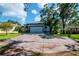 Home featuring a two-car garage and a circular driveway at 211 Arlington E Ave, Oldsmar, FL 34677
