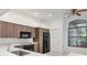 Well-lit kitchen featuring modern appliances, sleek cabinets, and a cozy breakfast nook near the window at 211 Arlington E Ave, Oldsmar, FL 34677