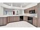 Open kitchen featuring sleek cabinets, modern appliances, and a breakfast bar overlooking the living area at 211 Arlington E Ave, Oldsmar, FL 34677