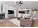 Open-concept living room with modern furnishings, a fireplace, and a view into the kitchen and front entrance at 211 Arlington E Ave, Oldsmar, FL 34677