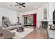 Bright living room with a fireplace, stylish furnishings, and large windows, offering a cozy ambiance at 211 Arlington E Ave, Oldsmar, FL 34677