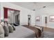 This main bedroom features a sliding glass door, an en-suite bathroom, and white walls with wood-look floors at 211 Arlington E Ave, Oldsmar, FL 34677