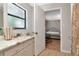 Clean bathroom with white cabinets and view to bedroom at 23924 Forest Pl, Land O Lakes, FL 34639