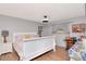 Well-lit bedroom with hardwood floors, large window and comfortable bed at 23924 Forest Pl, Land O Lakes, FL 34639