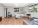 Cozy bedroom with hardwood floors, a rocking chair, and a comfortable bed at 23924 Forest Pl, Land O Lakes, FL 34639