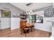 Inviting dining area with a round wood table, natural light, and stylish decor at 23924 Forest Pl, Land O Lakes, FL 34639