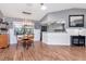 Bright dining area featuring an elegant light fixture and an adjacent kitchen with white cabinetry at 23924 Forest Pl, Land O Lakes, FL 34639
