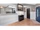 Entryway featuring wood flooring, white wainscotting, and an exterior door with glass at 23924 Forest Pl, Land O Lakes, FL 34639