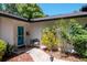 The front exterior features a blue front door and brick walkway on a well-landscaped lawn at 23924 Forest Pl, Land O Lakes, FL 34639