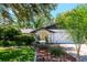 Charming home featuring a wrought iron gated courtyard, a two car garage, and a lovely lawn at 23924 Forest Pl, Land O Lakes, FL 34639