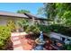 Charming home exterior featuring a well-maintained front yard, lush landscaping, and a decorative fountain at 23924 Forest Pl, Land O Lakes, FL 34639