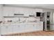 Modern kitchen with white cabinets, granite counters, stainless steel appliances, and hardwood floors at 23924 Forest Pl, Land O Lakes, FL 34639