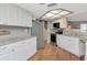 Well-lit kitchen with stainless steel appliances, granite countertops, and white cabinetry at 23924 Forest Pl, Land O Lakes, FL 34639