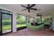 Screened lanai featuring a hammock, brick floor, dining table set and great outdoor view at 23924 Forest Pl, Land O Lakes, FL 34639