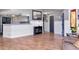 Open concept living area featuring hardwood floors, wainscoting, and gray painted walls at 23924 Forest Pl, Land O Lakes, FL 34639