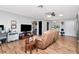 Open living area with wood flooring, a ceiling fan, and a comfortable couch at 23924 Forest Pl, Land O Lakes, FL 34639