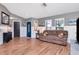 Open concept living area featuring hardwood floors, wainscoting, and gray painted walls at 23924 Forest Pl, Land O Lakes, FL 34639