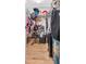 Image of walk-in closet with wood floor, shelves, clothing rack and a variety of organized items at 23924 Forest Pl, Land O Lakes, FL 34639