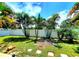 The backyard features a privacy fence and tropical trees at 2645 Woodring Dr, Clearwater, FL 33759