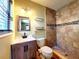 This bathroom features a standup shower with tile surround and updated vanity at 2645 Woodring Dr, Clearwater, FL 33759