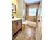 This bathroom features a shower-tub combination and an updated vanity at 2645 Woodring Dr, Clearwater, FL 33759