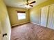 This bedroom features carpet flooring, neutral walls, and a double door closet at 2645 Woodring Dr, Clearwater, FL 33759