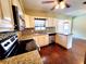 This kitchen features granite countertops, stainless steel appliances, and hardwood floors at 2645 Woodring Dr, Clearwater, FL 33759