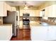 Bright kitchen features white cabinetry, stainless steel appliances, and a stylish backsplash at 2645 Woodring Dr, Clearwater, FL 33759