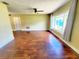 Spacious living room features hardwood floors, ceiling fan, and large windows for natural light at 2645 Woodring Dr, Clearwater, FL 33759