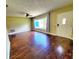 Inviting living room with gleaming hardwood floors, a ceiling fan, and a large window offering plenty of light at 2645 Woodring Dr, Clearwater, FL 33759