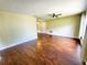 Bright living room boasts sleek hardwood floors, a contemporary ceiling fan, and neutral paint colors at 2645 Woodring Dr, Clearwater, FL 33759
