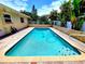 Enjoy the refreshing pool with brick surround and well-manicured landscaping at 2645 Woodring Dr, Clearwater, FL 33759