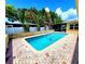 Enjoy a backyard pool surrounded by brick pavers and lush landscaping at 2645 Woodring Dr, Clearwater, FL 33759