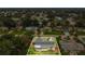 An aerial view showcases the property's layout, community, and location in a lush, green neighborhood at 2837 Woodcrest Dr, Sarasota, FL 34239