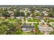 An aerial view showcases the home's location within a lush, green neighborhood at 2837 Woodcrest Dr, Sarasota, FL 34239