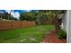 Large backyard features a privacy fence, mature landscaping, and room to roam at 2837 Woodcrest Dr, Sarasota, FL 34239