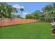 The expansive backyard features a lush green lawn, perfect for outdoor relaxation and activities at 2837 Woodcrest Dr, Sarasota, FL 34239