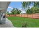 A spacious backyard boasts a well-maintained lawn, offering ample room for outdoor activities at 2837 Woodcrest Dr, Sarasota, FL 34239