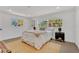 Bright bedroom featuring hardwood floors, white walls, and a comfortable bed with natural light from the windows at 2837 Woodcrest Dr, Sarasota, FL 34239