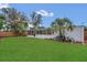 An exterior of the home features a well-maintained lawn and screened-in porch at 2837 Woodcrest Dr, Sarasota, FL 34239