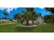 Charming single-story home features a well-manicured lawn and beautiful landscaping with mature palm trees at 2837 Woodcrest Dr, Sarasota, FL 34239