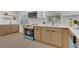 Stylish kitchen featuring stainless steel appliances, modern cabinets and tile backsplash at 2837 Woodcrest Dr, Sarasota, FL 34239