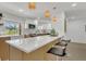 Bright kitchen featuring modern lighting, quartz countertops, and stylish bar seating at 2837 Woodcrest Dr, Sarasota, FL 34239
